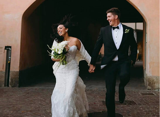 Bride and groom walking together outside a building