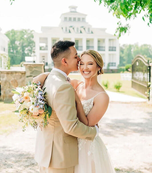 Bride and groom embracing outdoors